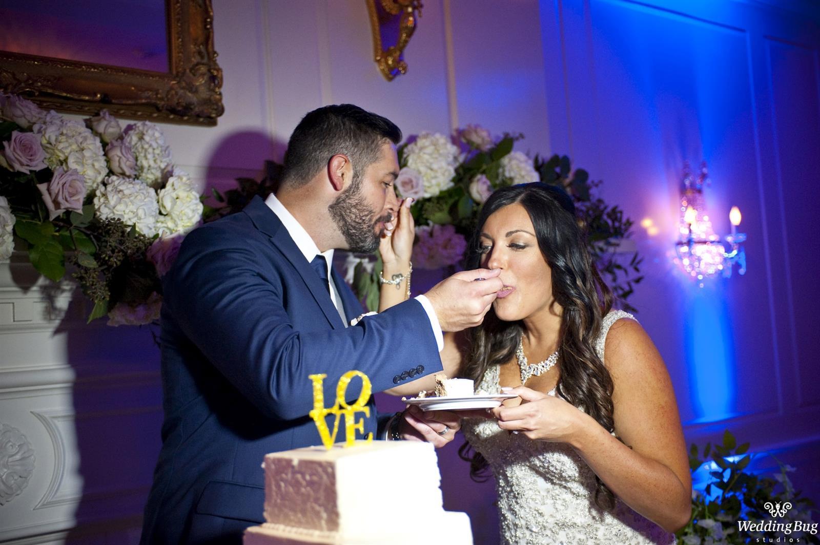 Cake Cutting, Blue Uplights highlight the reception